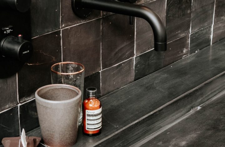 black modern faucet in a dark bathroom